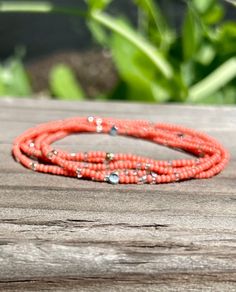 Made with coral pink Czech glass seed beads and complementary corrugated antiqued silver metallic beads, our wrap bracelets are designed to add a touch of bohemian flair to any outfit. Handcrafted with strong elastic cording, these stretchy bracelets effortlessly wrap around your wrist five times or around your neck two times as a choker-style necklace, providing a comfortable, lightweight, durable fit for all-day wear and active outdoor play.Each bracelet features a beautiful combination of see Silver Sprinkles, Boho Wrap Bracelet, Choker Style Necklace, Beaded Wrap Bracelets, Coral Peach, Wrap Bracelets, Beaded Wraps, Boho Bracelet, Stretchy Bracelets