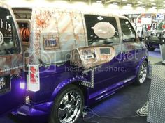 a purple van is on display in a showroom