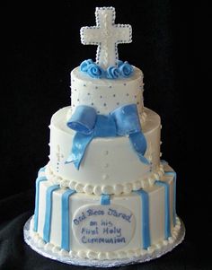 a white and blue cake with a cross on top