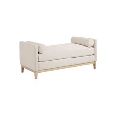 a white couch sitting on top of a wooden frame