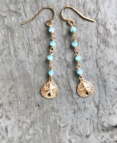 Dainty Gold Sand Dollar Earrings These cute beachy earrings feature detailed sand dollars which swing from a beaded chain of glowing, aqua-blue chalcedony. I personally wire-wrap the stones by hand, using 14k gold-filled wire, for a beautiful finish which won't tarnish or rub off like gold-plating. Lots of shimmery detail, perfect for summer days (and summer dreaming). Ideal for your beach holiday or wedding. Makes a lovely gift. GEMSTONES: Aqua-blue chalcedony - faceted rondelles, 3 mm LENGTH: Blue Dangle Earrings For The Beach, Teardrop Beaded Jewelry For The Beach, Beaded Dangle Beach Jewelry, Beaded Teardrop Jewelry For The Beach, Turquoise Wire Wrapped Earrings For Beach, Beaded Dangle Jewelry For The Beach, Gold Dangle Teardrop Earrings For Beach, Beaded Dangle Jewelry For Beach, Blue Dangle Beaded Earrings For Beach