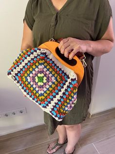 ✈️✈️✈️  READY TO SHIP ✈️✈️✈️  Crochet Vintage Style Granny Square Clutch with Wooden Clasp Step into timeless elegance with our handcrafted Crochet Vintage Style Granny Square Clutch. This stunning accessory combines classic charm with modern functionality, making it a perfect addition to any wardrobe. Key Features: 📍 Unique Granny Square Design: Each clutch features intricately crocheted granny squares, showcasing a vintage aesthetic that never goes out of style. 📍 Secure Wooden Clasp: The wo Brown Handheld Crochet Bag, Multicolor Crochet Bag Made Of Yarn, Handmade Retro Multicolor Crochet Bag, Retro Multicolor Crochet Bag With Granny Square Details, Multicolor Retro Crochet Bag With Granny Square Details, Retro Multicolor Crochet Bag With Granny Square, Multicolor Retro Crochet Bag With Granny Square, Square Hand-knitted Crochet Bag, Granny Square Clutch