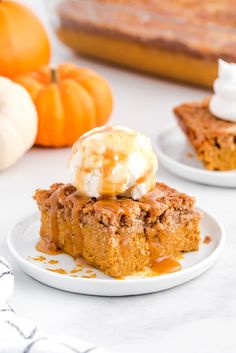 there is a piece of cake on the plate with ice cream and pumpkins in the background