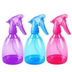 three different colored spray bottles are shown