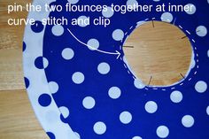 a blue and white polka dot bib with the words pin the two francess together at inner curve, stitch and clip