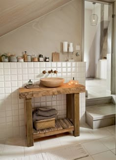 a bathroom with a wooden sink and tiled walls