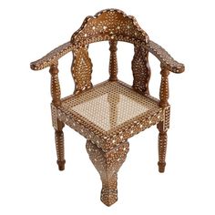 an ornate wooden chair with intricate carvings on the back and sides, sitting against a white background