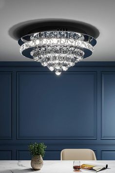 a dining room table with chairs and a chandelier hanging from it's ceiling