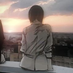 two people looking out over the city at sunset