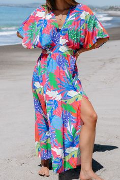 Embrace weekend vibes in the Bright Tropical Smocked Maxi Dress. Perfect for brunch with friends or a family gathering, its easy-going style and bright print make every day feel like a getaway. Product code: CAA05A4D165EE Features:  Knit V-neck Smocked waist Maxi Pattern: Tropical Material: 100%RAYON. Jungle Dress, Maxi Pattern, Pattern Dresses, Smocked Maxi Dress, Tropical Outfit, Hawaii Outfits, Prom Dress Shoes, Swimsuits Bikinis, Affordable Swimwear