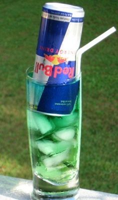 a glass filled with ice and water sitting on top of a table