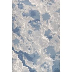 a blue and white rug with clouds on it