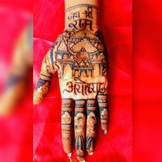 a person's hand with henna tattoos on it and the words written in different languages