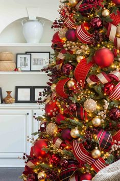 a christmas tree decorated with red and gold ornaments