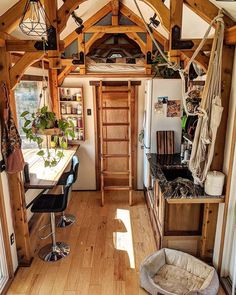 a dog bed in the middle of a room with wood floors and wooden beams on the ceiling