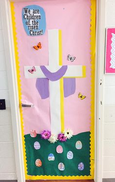 a door decorated with paper flowers and a cross on the front, saying we are children of the lord christ