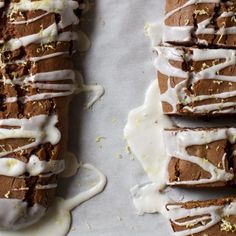 some brownies with white icing on top of a table