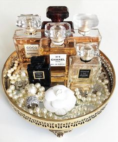 an assortment of perfumes and pearls in a basket