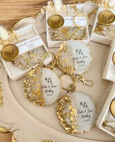 gold and white wedding favors on a tray