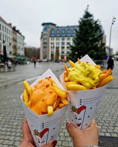 two people are holding up some food in their hands