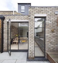 an outdoor area with brick walls and glass doors