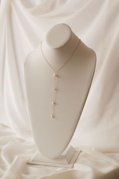 If you're looking for a statement for your big day, look no further. Our Pearl Back Drop Necklace features a 5" front drop and a 7" back drop, adorned with hand fastened freshwater pearls to finish the look. This piece is classic, elegant, and sure to make you like the beautiful bride you are on your special day. Includes 10 freshwater pearls + 16" neck length of 14k gold-filled cable cha Formal Dangle Pearl Drop Necklace, Elegant Long Drop Pearl Necklace, Adjustable Pearl Pendant Necklace For Wedding, Elegant Pearl Dangle Lariat Necklace, Long Drop Pearl Pendant Necklace For Wedding, White Pearl Drop Backdrop Necklace, Elegant Pearl Lariat Dangle Necklace, Long Drop Pearl Charm Necklace For Wedding, Formal Pearl Drop Necklace With Pearl Charm