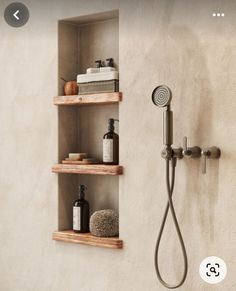 the shower head is mounted on two wooden shelves