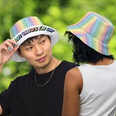 The perfect accessory for anyone who loves rainbows and isn't afraid to show off their pride! Our pastel rainbow bucket hat is the ultimate statement piece, featuring a bold and colorful design that's sure to turn heads. And with the playful message "Nobody Knows I'm Gay" emblazoned across the brim in matching pastel rainbow font, you can let the world know your true colors without saying a word.But that's not all – this versatile hat is also reversible, with a classic white side that lets you s Adjustable Rainbow Hats For Summer, Adjustable Rainbow Summer Hats, Adjustable Summer Rave Hats, Casual Adjustable Rainbow Hat, Multicolor Cotton Hat For Streetwear, Playful Summer Streetwear Hats, Fun Multicolor Bucket Hat For Spring, Multicolor Bucket Hat For Summer Streetwear, Casual Rainbow Hat, One Size Fits Most