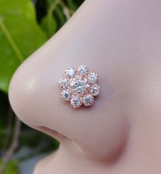 a close up view of a woman's breast with diamond studs on it