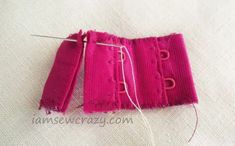 two pieces of pink fabric are being sewn together