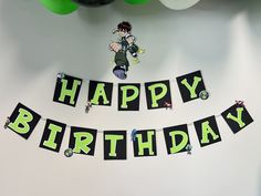 a birthday banner that says happy birthday hanging on a wall next to balloons and streamers