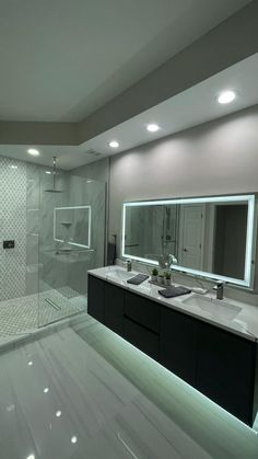 a bathroom with two sinks and a large mirror