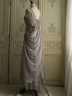 a mannequin is dressed in a dress with a long veil on it's head