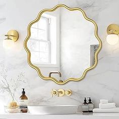 a bathroom with a sink, mirror and soap dispenser on the counter