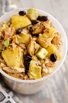 a bowl filled with rice and fruit on top of a table