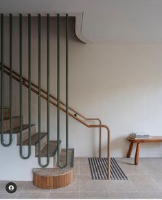 an empty room with some stairs and a table on the floor in front of it