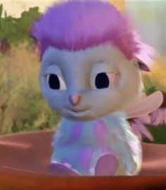 a cartoon character with pink hair and blue eyes sitting in front of purple flowers on a table