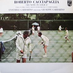 two men holding tennis racquets on top of a tennis court