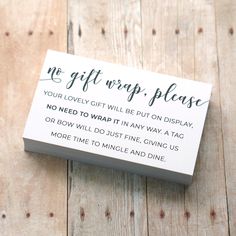 no gift wrap please card sitting on top of a wooden table