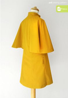 a mannequin is dressed in a yellow dress