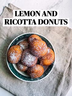 lemon and ricotta donuts on a plate with powdered sugar