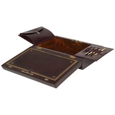 a wooden tray with two compartments and gold trimmings