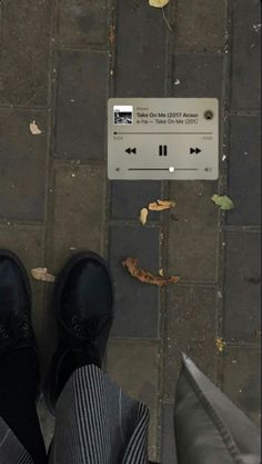 a person standing on the sidewalk with their feet up