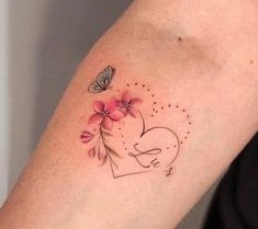 a woman's arm with pink flowers and a butterfly on the left side of her arm