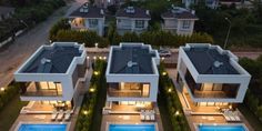 an aerial view of three houses with swimming pool