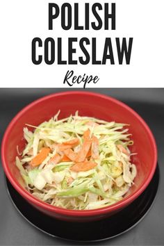 a red bowl filled with coleslaw and carrots on top of a black plate