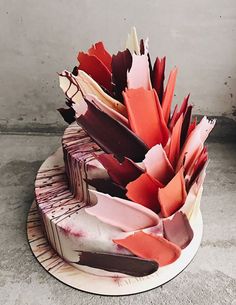 an image of a cake that is made out of paper and has been placed on a plate