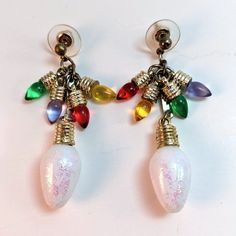 A Hand-Crafted Pair Of Christmas Light Dangle Earrings. Features White Iridescent Sparkle Christmas Light Bulbs Dangling Below, Crowned With Four Tiny Yellow, Red, Green, And Blue Bulbs Above. Post Back, Measures Approximately 2.25" Long. Keywords: Christmas Lights, Dangle, Cluster, Iridescent, Primary Colors, Colorful, Rainbow, Statement, Christmas, Festive, Winter, Holidays, Handmade Sparkle Christmas, Christmas Light Bulbs, Christmas Light, Colorful Rainbow, Green And Blue, Winter Holidays, Handmade Christmas, Light Bulbs, Christmas Lights