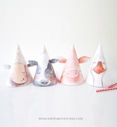 five paper hats with animals painted on them