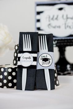 two black and white napkins with polka dots are sitting on top of each other